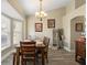Well-lit dining area with a chandelier, wood table and chairs, and natural light at 3342 Sanborn Ln, Deltona, FL 32738