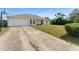 Charming single-story home with a well-maintained lawn, mature landscaping, and attached garage at 3342 Sanborn Ln, Deltona, FL 32738