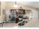Open kitchen with stone countertops, stainless steel appliances, and a view of the dining area at 3342 Sanborn Ln, Deltona, FL 32738