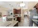 Bright kitchen featuring stone countertops, stainless steel appliances, and access to dining area at 3342 Sanborn Ln, Deltona, FL 32738