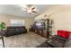 Spacious living room is nicely decorated with ceiling fan and large entertainment center at 3342 Sanborn Ln, Deltona, FL 32738