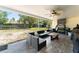 Relaxing covered patio with stylish seating area, ceiling fan, and a view of the spacious backyard at 3342 Sanborn Ln, Deltona, FL 32738