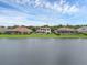 An aerial view showing backyard pools on homes by the lake with manicured lawns under a cloudy sky at 4031 Bermuda Grove Pl, Longwood, FL 32779
