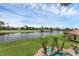 An elevated view of the backyard, offering views of a lake and the golf course beyond at 4031 Bermuda Grove Pl, Longwood, FL 32779