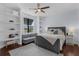 Light-filled bedroom features a large window with a scenic lake view and comfortable seating area at 4031 Bermuda Grove Pl, Longwood, FL 32779