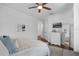 Bright bedroom with hardwood floors and a cozy bed with a TV and a mirror at 4031 Bermuda Grove Pl, Longwood, FL 32779