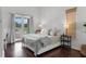 Bright bedroom featuring french doors, hardwood floors, and neutral decor with a view of the golf course at 4031 Bermuda Grove Pl, Longwood, FL 32779