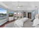 Bright and open bedroom featuring a ceiling fan and views of the lake at 4031 Bermuda Grove Pl, Longwood, FL 32779