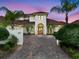 Stately home with a paver driveway, meticulous landscaping, and a grand entrance offers impressive curb appeal at 4031 Bermuda Grove Pl, Longwood, FL 32779