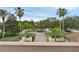 Beautiful landscaped front yard with palm trees, a brick walkway, and a circular driveway at 4031 Bermuda Grove Pl, Longwood, FL 32779