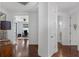 Hallway with hardwood floors leading to an office space and other rooms at 4031 Bermuda Grove Pl, Longwood, FL 32779