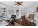 Comfortable home office featuring hardwood floors, built-in bookcases and work space at 4031 Bermuda Grove Pl, Longwood, FL 32779
