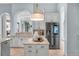 Well-lit kitchen with stainless steel appliances, marble countertops, and custom cabinetry for ample storage at 4031 Bermuda Grove Pl, Longwood, FL 32779