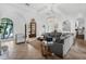 Bright, airy living room featuring tile floors, arched doorways, and a comfortable seating area at 4031 Bermuda Grove Pl, Longwood, FL 32779