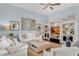 Comfortable living room with a large entertainment center, a ceiling fan and natural lighting at 4031 Bermuda Grove Pl, Longwood, FL 32779