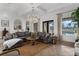 Spacious living area with a plush sectional sofa, stylish lighting, and large windows overlooking the pool at 4031 Bermuda Grove Pl, Longwood, FL 32779