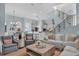 Open concept living space with view to kitchen and dining. Features a staircase and comfortable furniture at 4031 Bermuda Grove Pl, Longwood, FL 32779