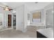 Well-lit bathroom featuring a soaking tub, tile flooring, and access to a walk-in closet at 4031 Bermuda Grove Pl, Longwood, FL 32779