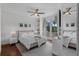 Bright main bedroom with hardwood floors, ceiling fan, and French doors at 4031 Bermuda Grove Pl, Longwood, FL 32779
