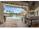 Covered patio with a swing and a view of the pool, and a golf course in the distance at 4031 Bermuda Grove Pl, Longwood, FL 32779