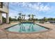 Stunning pool with a water feature and palm trees, backing to a serene lake at 4031 Bermuda Grove Pl, Longwood, FL 32779