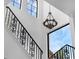 Elegant staircase showcasing high ceilings, decorative wrought iron railing, and natural light from large windows at 4031 Bermuda Grove Pl, Longwood, FL 32779