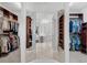 Spacious walk-in closet with ample shelving and hanging space, visible from bathroom at 4031 Bermuda Grove Pl, Longwood, FL 32779