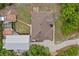 Aerial view shows home with outbuilding, garden, and metal garage providing many storage options at 41128 Apple St, Eustis, FL 32736
