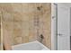 Bathroom shower and tub with tan tile, decorative trim, and a white shower curtain at 41128 Apple St, Eustis, FL 32736