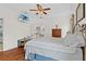 Comfortable bedroom with wood floors, television, and an adjoining bathroom view at 41128 Apple St, Eustis, FL 32736