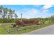 The Royal Trails community sign in brick with landscaping and fencing provides a welcoming entrance at 41128 Apple St, Eustis, FL 32736