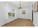 Bright dining room with tiled floors, chandelier, and a large window at 41128 Apple St, Eustis, FL 32736