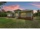 Charming single-story home with a screened entrance and mixed material facade at 41128 Apple St, Eustis, FL 32736