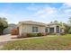 Well-maintained home with a detached garage, lush landscaping, and inviting curb appeal at 41128 Apple St, Eustis, FL 32736