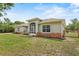 Charming single-story home with a screened entrance and mixed material facade at 41128 Apple St, Eustis, FL 32736
