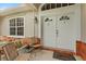 Inviting front porch with seating area, decorative features, and a double door entryway at 41128 Apple St, Eustis, FL 32736