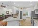 Bright kitchen with white cabinetry, granite countertops, stainless steel appliances, and a pantry for storage at 41128 Apple St, Eustis, FL 32736