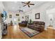 Spacious living room with high ceilings, hardwood floors, and comfortable leather furniture at 41128 Apple St, Eustis, FL 32736