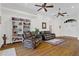 Spacious living room with wood floors, comfortable seating, and a built-in bookcase for ample storage at 41128 Apple St, Eustis, FL 32736