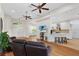 Bright living room with wood floors that seamlessly flows into the kitchen, creating an inviting and open space at 41128 Apple St, Eustis, FL 32736