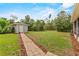 Outbuilding with neutral color with stone walkway and a grassy lawn adds character to this home at 41128 Apple St, Eustis, FL 32736