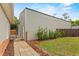 This outbuilding has metal siding and a stone path leading to a door with a well-maintained lawn at 41128 Apple St, Eustis, FL 32736