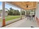 Screened porch with a view of the green, wooded yard at 41128 Apple St, Eustis, FL 32736