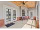 Covered porch with brick accents, seating, and ample natural light at 41128 Apple St, Eustis, FL 32736