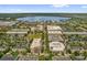 Scenic aerial view of the neighborhood with storefronts, parking, and beautiful lake at 4284 New Broad St # 102, Orlando, FL 32814