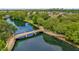Aerial view of the waterway and community bridge amid lush landscaping at 4284 New Broad St # 102, Orlando, FL 32814