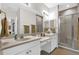 Bathroom with double sinks, a large mirror, and a glass-enclosed shower at 4284 New Broad St # 102, Orlando, FL 32814