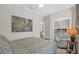 Relaxing bedroom featuring a queen-sized bed, a seating area and a mirrored closet at 4284 New Broad St # 102, Orlando, FL 32814