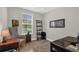 Cozy bedroom featuring natural light, a decorative ladder shelf, and wood flooring at 4284 New Broad St # 102, Orlando, FL 32814