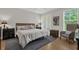 Comfortable bedroom with a large bed, soft lighting, and access to a balcony at 4284 New Broad St # 102, Orlando, FL 32814